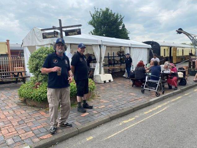 A group of people outside a tent

Description automatically generated with medium confidence