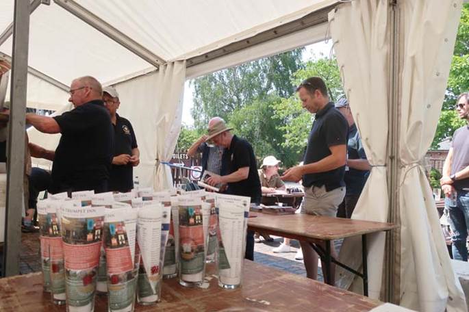 A group of men standing in a tent

Description automatically generated with low confidence