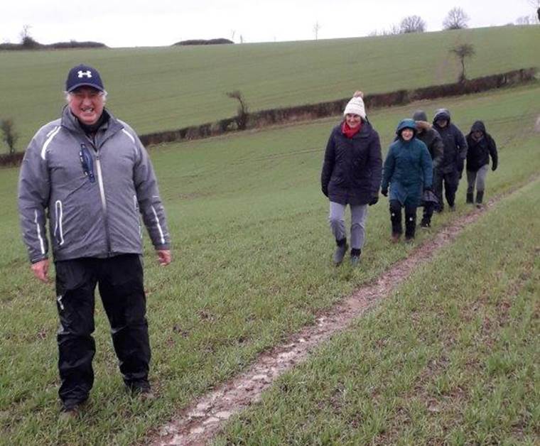 A group of people walking on a dirt path

Description automatically generated with medium confidence