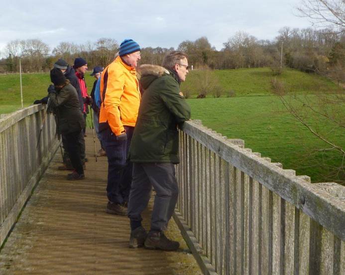 A group of people standing on a bridge

Description automatically generated with medium confidence