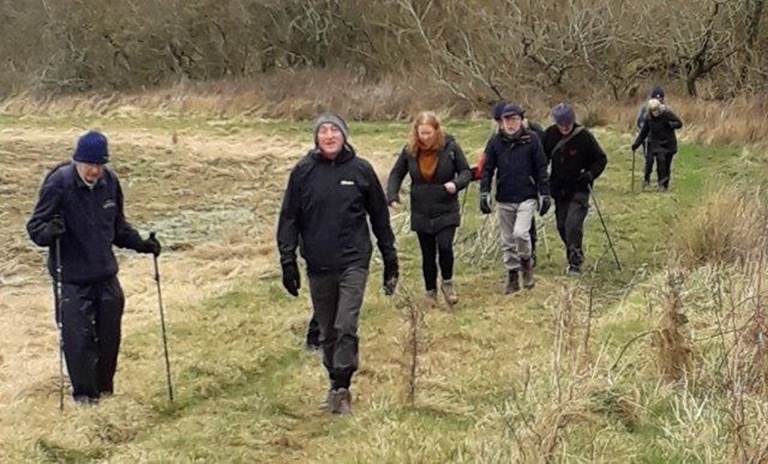 A group of people walking in a field

Description automatically generated with medium confidence