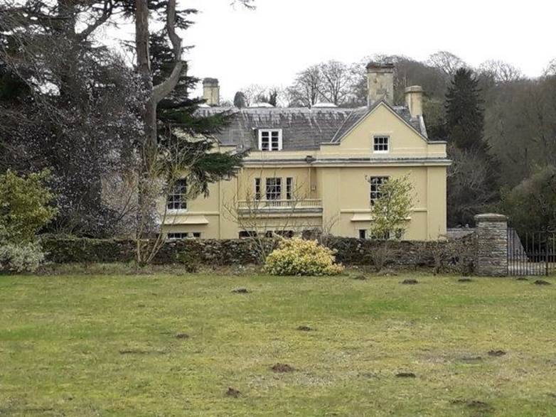 A large house with a lawn in front of it

Description automatically generated with low confidence