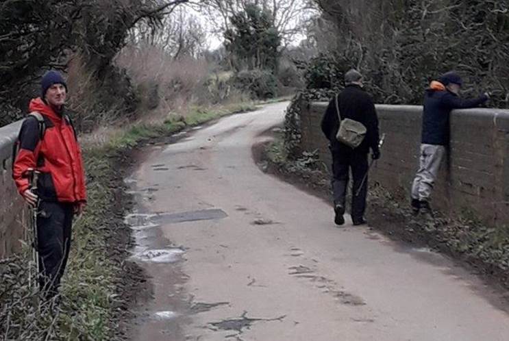 A group of people walking on a path in the woods

Description automatically generated with medium confidence