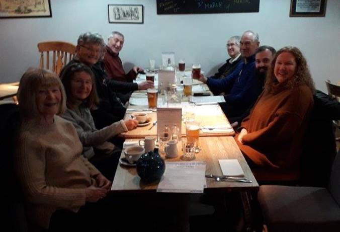 A group of people sitting around a table

Description automatically generated