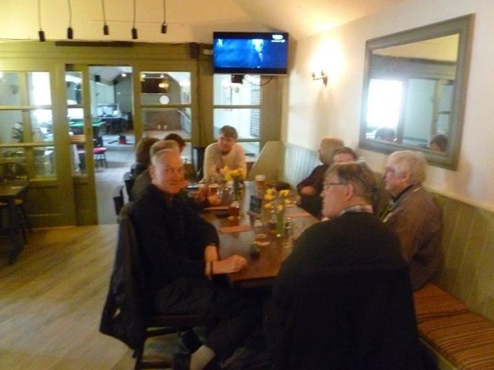 A group of people sitting around a table

Description automatically generated with medium confidence