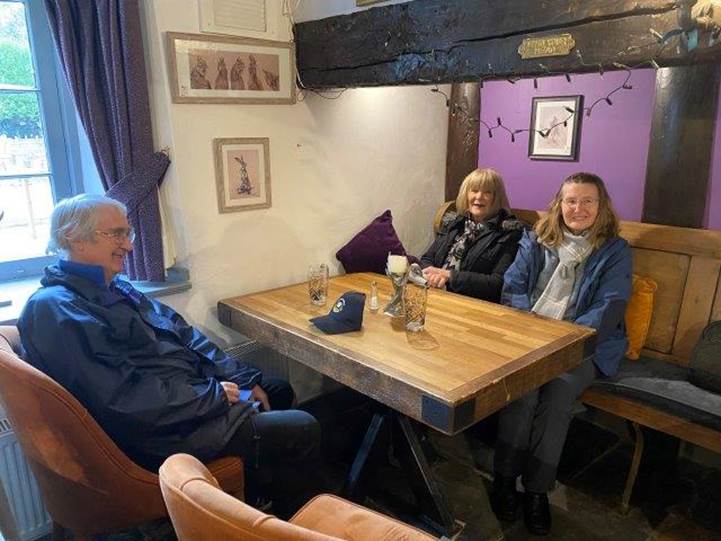 A group of people sitting around a table

Description automatically generated with medium confidence