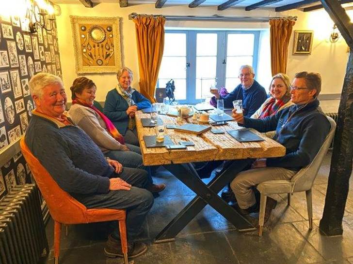 A group of people sitting around a table

Description automatically generated with medium confidence