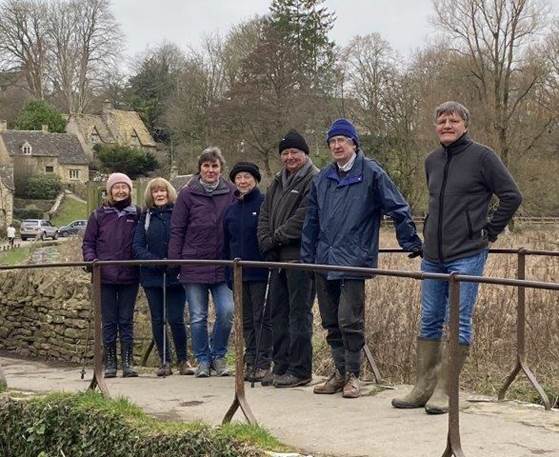 A group of people standing by a fence

Description automatically generated with medium confidence