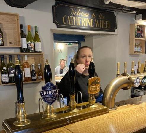 A person behind a bar

Description automatically generated with low confidence