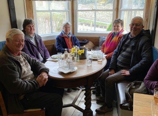 A group of people sitting around a table

Description automatically generated